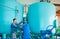 Serviceman operating industrial water purification or filtration equipment