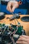 Serviceman replacing water seals on robotic lawnmower, motorized lawnmower being serviced on a table after a year of use in the