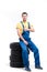 Serviceman sitting on tires, white background