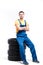 Serviceman sitting on tires, white background