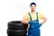 Serviceman sitting on tires, white background