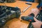 Serviceman stripping and removing electric motors on robotic lawnmower, motorized lawnmower being serviced on a table after a year