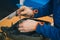 Serviceman stripping robotic lawnmower with imbus tool, motorized lawnmower being serviced on a table after a year of use in the