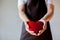 Servicing man in apron holding heart - customer relationship and