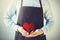 Servicing man in apron holding heart - customer relationship and service minded business concept