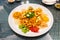 Serving of auspicious yusheng or yee sang with abalone in restaurant during Chinese New Year celebration