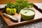 serving bowl of soup on a wooden tray with a spoon