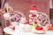 Serving festive table of appetizing cakes, sweet desserts, fresh strawberry and raspberry, person hand pour tea into