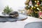 Serving a festive table with plates, forks, knives, napkins close-up tissue in a cage decorated for Christmas and New Year pine