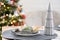 Serving a festive table with plates, forks, knives, napkins close-up tissue in a cage decorated for Christmas and New Year pine