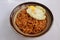 serving fried noodles in a bowl with an egg on top