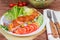 Serving of grilled trout fillet among vegetables on rustic table