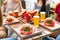 Serving of hamburgers and cold beers at a restaurant table