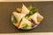 serving of Hindu vegetable samosa with lettuce and carrot garnish on a table