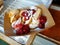 Serving of mini pancakes with raspberry jam and powdered sugar. Traditional local delicacy in Tallinn, Estonia.