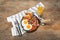 Serving pan with fried eggs, mushrooms, beans, bacon, tomatoes and bread on wooden table, flat lay. Traditional English