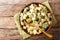 Serving potato salad with yogurt, herbs, spices and dried olives closeup in a bowl. Horizontal top view