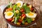 Serving salad of lupine beans, boiled eggs, tomatoes and feldsalat close-up in a plate. horizontal