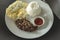 A serving of Tapsilog served with garlic rice, scrambled egg, and ketchup. A Filipino breakfast