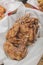 A serving of Teriyaki Chicken wings at a restaurant. On a tray covered with greaseproof paper