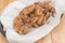 A serving of Teriyaki Chicken wings at a restaurant. On a tray covered with greaseproof paper