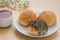 Sesame buns on plate and tea cup