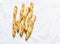 Sesame puff pastry breadsticks on a light background, top view