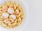 Sesame sauce on macaroni with seafood in white bowl. on butter cream color background.