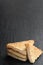 Sesame seeded prawn toasts on black stone background