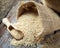 Sesame seeds in sack on rustic table