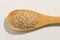 Sesamo. Nutritious grains on a wooden spoon on white background.