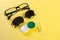 A set of accessories for sight. Pinhole glasses, lenses with container and glasses for sight. Pair of medical pinhole glasses with