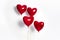 Set of Air Balloons. Bunch of red color heart shaped foil balloons isolated on white background. Love.