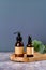 Set of amber glass cosmetics bottles on wooden board with eucalyptus. Beauty products packaging design