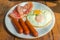 Set of american breakfast with bacon, fried eggs and sausage on