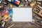 Set of artist accessories collection. Canvas, tube of oil paint, art brushes, palette knife lying on the wood table. Artist works