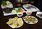 Set of Asia sea food with Coconut Escargot, barbecue razor clam, cheese grilled oyster, boiled vegetable eating with braided fish