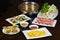 Set of Asian food with Fried Crispy Potato, Barbecue geoduck with onion and grease, Shrimp stir-fried vermicelli, hot pot with raw