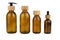 Set of assorted brown glass bottles with wooden lids for cosmetics. Dispenser with a straw and a pipette. Eco concept