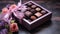 A set of assorted chocolates in a paper box with a purple ribbon