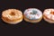 Set of assorted donuts with blue glaze, sprinkle, almond crumbs, chocolate and marshmallows close-up isolated on a purple