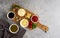 Set, assortment of sauces, ketchup, mayonnaise, cheese, soy, green, on a cutting board, with ingredients, on a gray