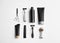 Set of barber`s equipment and men`s cosmetic products on light background