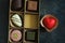 Set of beautiful sweets in a close-up box on a dark marble background. Top view, natural light. The concept of holidays,