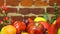 Set of berries and fruits in wooden box. Apple, strawberry, grape, berry and peach on a defocused red brick background