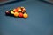 Set of billiard balls triangle on blue billiard pool table