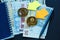 Set of bitcoin, ethereum - crypto currency next to notepad on real money background. Time is money. Internet e-commerce, security