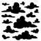 Set of black fluffy clouds silhouettes on white background. Illustration in flat cartoon style. Elements for your design