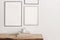 Set of black portrait picture frame mockups. Wall art gallery. Cup of coffee on pile of books on old wooden bench, table