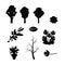 Set of black tree silhouettes branches of flying leaves of flowers on white isolated background